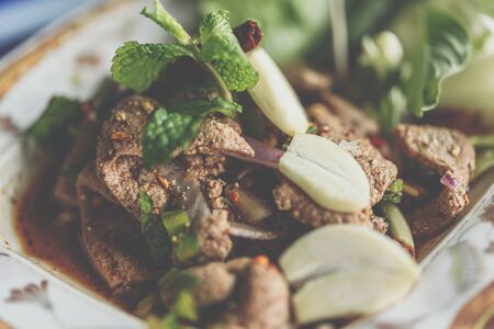 Spicy Pork Liver Salad (Tub Wan) is a Thai Esan food for sale at Thai street food market or restaurant in Thailandの写真素材