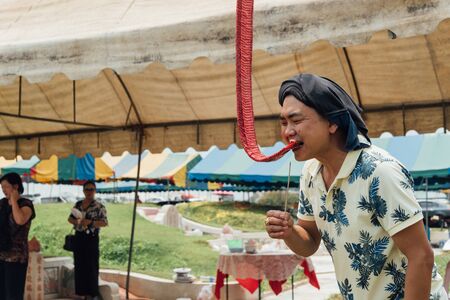 Prachinburi, Thailand - April 7, 2019 : Thai Chinese respect ancestors parents those died by food and burn fake money to sacrifice them at cemetery in Qingming Festival (Qing Ming), Tomb-Sweeping Dayのeditorial素材