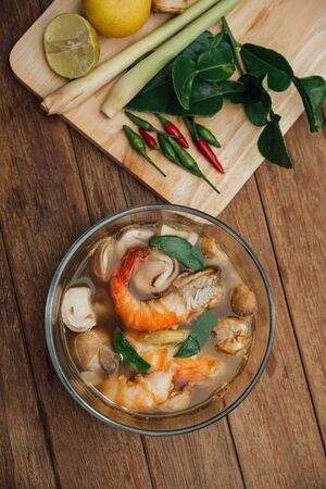 Hot and sour seafood soup (Tom Yum) for sale at Thai street food market or restaurant in Thailand