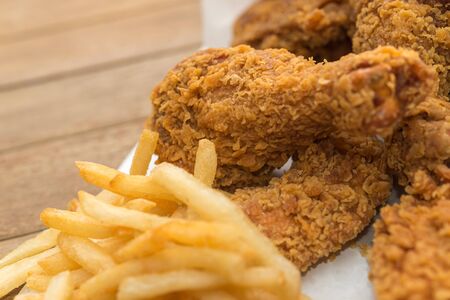 Fried chicken crispy food from chicken and French fries or chips (potato) is a side dish or snack in fastfood restaurant, unhealthy food or fat concept at Thai street food marketの写真素材