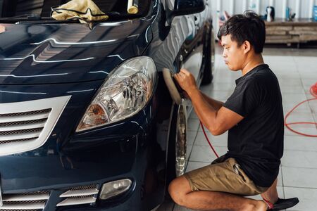 Bangkok, Thailand - November 9, 2019 : Unidentified car care staff cleaning (clean, wash, polish and wax) the car (Car detailing) at car care shop in Bangkok Thailandのeditorial素材