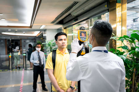 Bangkok, Thailand - March 16, 2020 : Unidentified people waiting body temperature check to access building for against epidemic flu covid19 or corona virus by thermoscan or infrared thermal cameraのeditorial素材