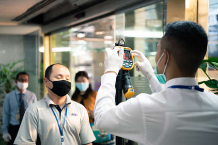 Bangkok, Thailand - March 16, 2020 : Unidentified people waiting body temperature check to access building for against epidemic flu covid19 or corona virus by thermoscan or infrared thermal cameraのeditorial素材
