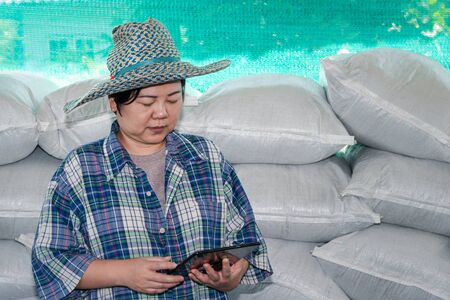 Asian woman smart farmer agriculturist happy at a Fertilizer composting plant with Organic...