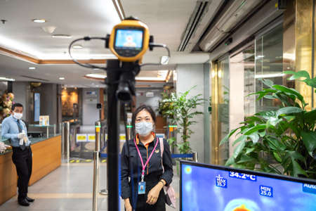 Bangkok, Thailand - March 18, 2020 : Unidentified people waiting body temperature check to access building for against epidemic flu covid19 or corona virus by thermoscan or infrared thermal cameraのeditorial素材