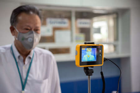 Bangkok, Thailand - March 18, 2020 : Unidentified people waiting body temperature check to access building for against epidemic flu covid19 or corona virus by thermoscan or infrared thermal cameraのeditorial素材