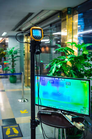 Bangkok, Thailand - March 17, 2020 : Unidentified people waiting body temperature check to access building for against epidemic flu covid19 or corona virus by thermoscan or infrared thermal cameraのeditorial素材