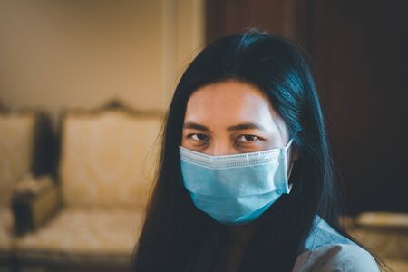 Asian pretty woman wearing mask respiratory protection mask against epidemic flu covid19 or corona...