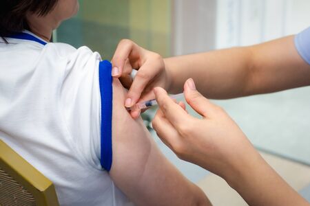 Patient asian woman health check by get vaccinated against the flu covid19 or corona virus every year by the Ministry of Health at hospital in concept illness, outbreak, healthcare in lifeの写真素材