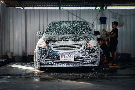Bangkok, Thailand - February 16, 2020 : Unidentified car care staff cleaning (clean, wash, polish, wax and glass coating) the car (Car detailing) at car care shop in Bangkok Thailandのeditorial素材