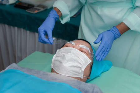 Asian woman eyebrow tattooing by doctor specialist in Eyebrow tattoo clinic or Eyebrow embroidery...