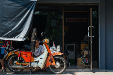 Bangkok, Thailand - May 16, 2020 : Unidentified mechanic or serviceman checking a classic retro motorcycle (Japan motorcycle vintage style) for fix and repair problem at garage or repair shopのeditorial素材