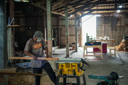 Bangkok, Thailand - May 1, 2020 : Unidentified carpenter build furniture or products from slat and timber wood from natural hardwood in warehouse or sawmill at wood factory for a construction or saleのeditorial素材
