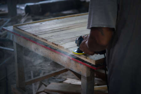 Asian carpenter build furniture or products from slat and timber wood from natural hardwood in...