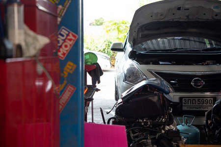 Bangkok, Thailand - April 4, 2020 : Unidentified car mechanic or serviceman checking a car engine for fix and repair problem at car garage or repair shopのeditorial素材