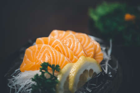 Japanese food delicacy consisting sashimi salmon of very fresh raw salmon fish sliced into thin...
