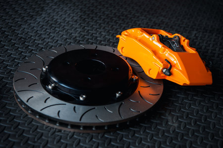 Car mechanic or serviceman disassembly and checking a disc brake and asbestos brake pads for fix and repair problem at car garage or repair shopの写真素材