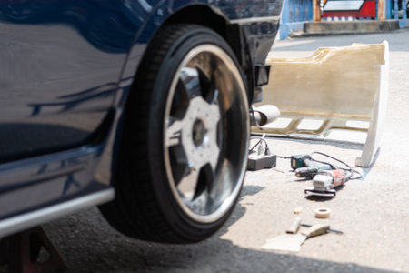 Denter or car mechanic serviceman check and fix body work and fiber bumper body part for fix and...