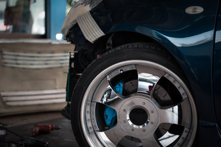 Denter or car mechanic serviceman check and fix body work and fiber bumper body part for fix and repair problem at car garage or repair shopの写真素材