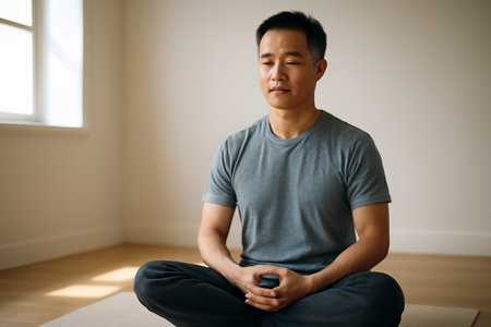 AI generated man meditating peacefully in a sunlit minimalist room. The calm, focused moment radiates tranquility and inner peace, perfect for mindfulness and wellness themes.の素材