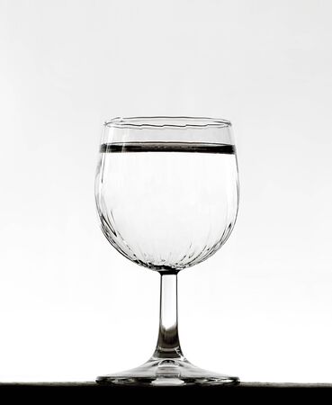 glass of water put on wooden table on the white backgroundの写真素材