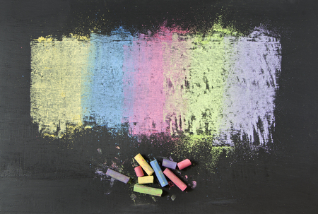 colorful chalks on blackboard background.の写真素材