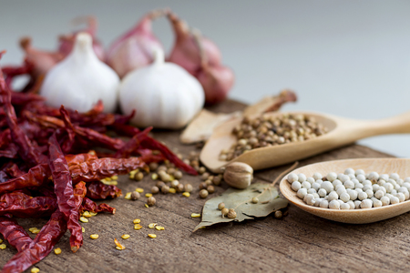 Food ingredients, peppercorn and red dry chilli peppers on wooden table, asian food cooking concept.の写真素材