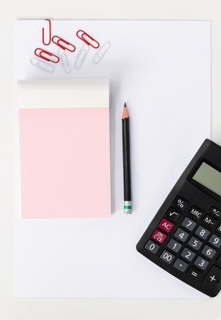 blank sheet of paper, notepad  and calculator on white table. concept business and educationの写真素材