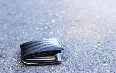black leather wallet drop on the road. concept missing or lost a pocketの写真素材