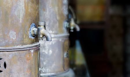 Old vintage brass faucet, The ancient medicinal pot with the brass faucet in the open, pour the medication.の写真素材