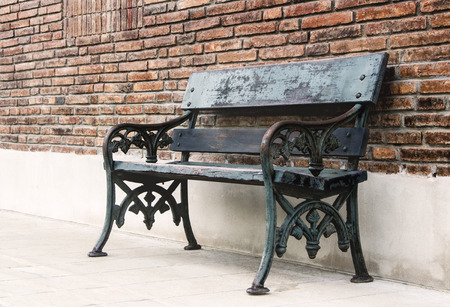 Long bench chair and wall brick background, with copy space for texture.の写真素材