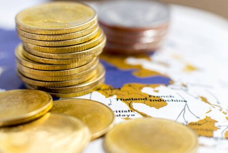Coins stack on a paper map. The concept of business growth, financial or money savings.