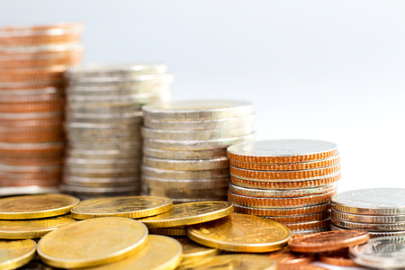 Coins stack on white background, concept of business growth, financial or money savings, with copy space for text.の写真素材