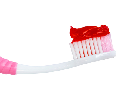 Red toothpaste is on the toothbrush isolated on white background. Dental Care Concept. with clipping path.の写真素材