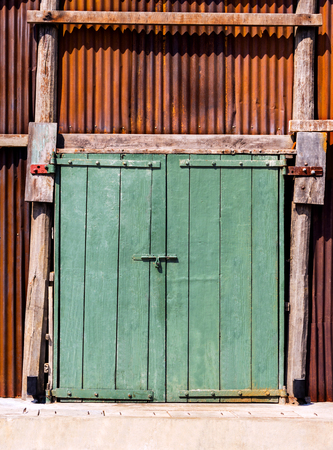 The old vintage retro door made of hardwood and old zine with rust background. with copy space for your text.の写真素材