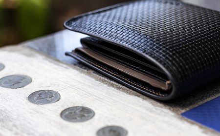 Wallet and us dollar coins on the table.