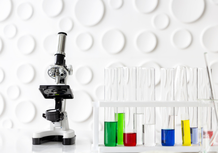 Microscope and laboratory glassware on white table in a laboratory. selective focus.