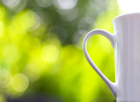 Coffee Cup with bokeh is a bright green backdrop. The concept of the freshness of the morning.の写真素材