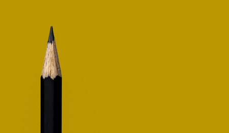 Closeup back pencil isolated on yellow background.の写真素材