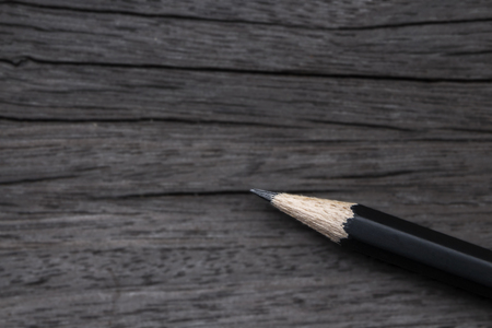 Closeup back pencil isolated on wood table background.の写真素材