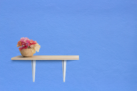 Decorated interior on shelf with flower. Blue wall texture background.の写真素材