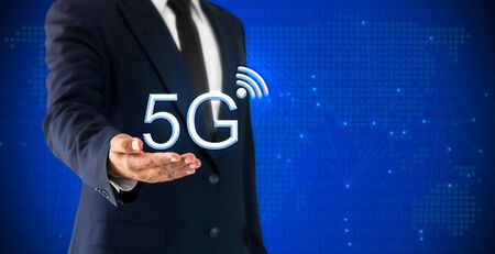 Businessman showning 5G Network Internet Mobile Wireless that represents the concept of high-capacity transmission technique.の写真素材