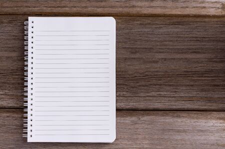 Blank notebook isolated on wood table background  with copy space for your text or image.