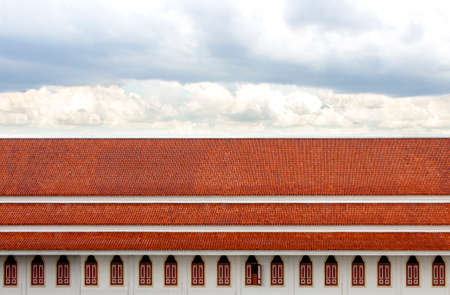 Windows and roof made of tile wiht beautiful sky background.の写真素材