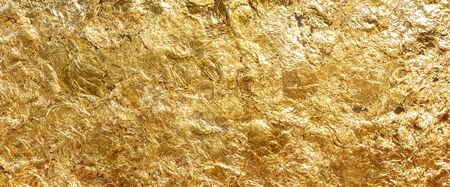 Texture of shiny gold leaf beautiful. Gold that has been smashed into thin sheets is used to close the gold to worship the Buddha.の写真素材