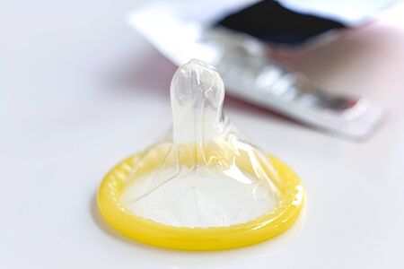 Condom isolated on white tableの写真素材