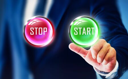 The businessman show the hands touch the start button that represents the start of the business and future success.の写真素材