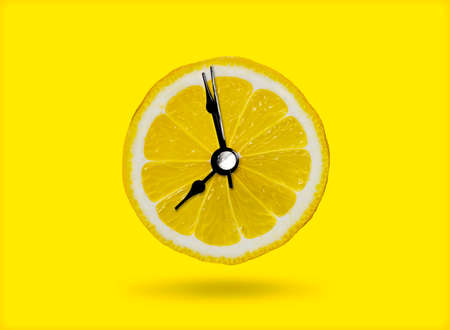 Lemon and the clock are the idea of ââa healthy breakfast or a bright morning awakening.の写真素材