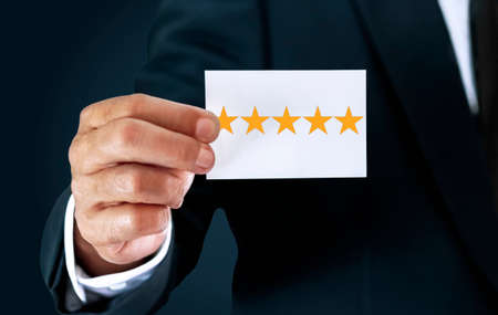 A businessman confident of success, he holds a white card with a rating of five stars or the...