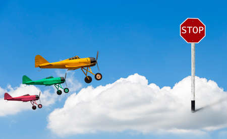 The stop sign is embroidered on clouds and models of vintage military propeller plane modelの写真素材